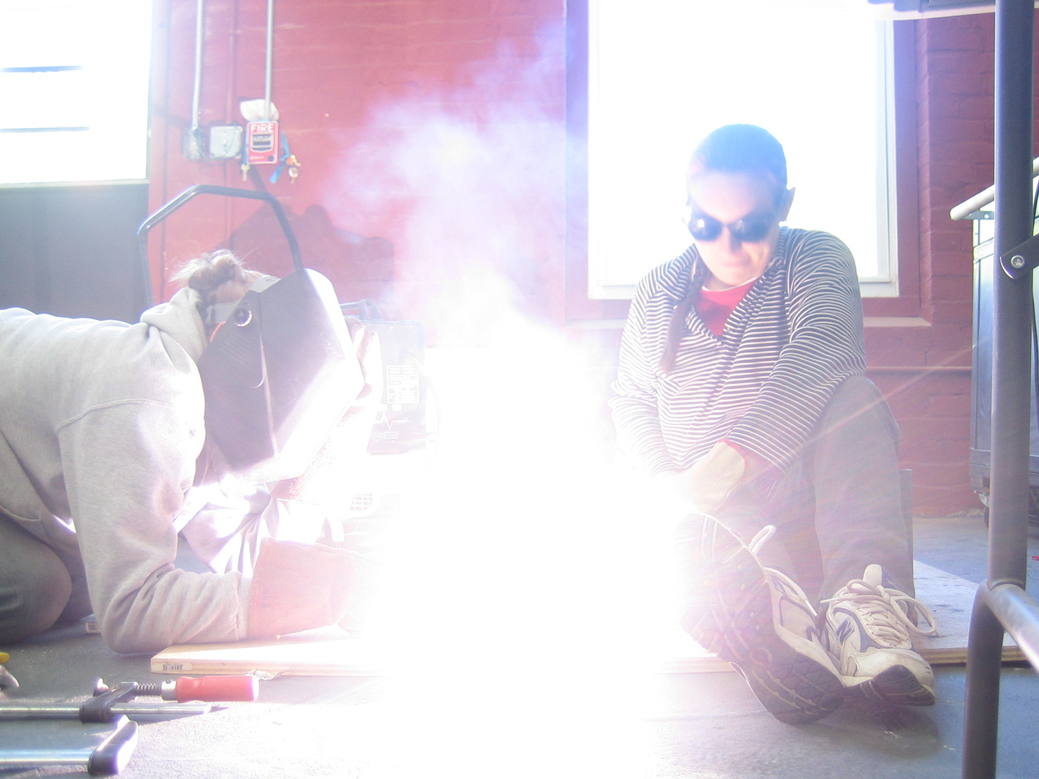 A bright welding spark flash lighting up the studio